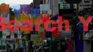At Home vibrant irish street with heraldic county flags and shop signs
