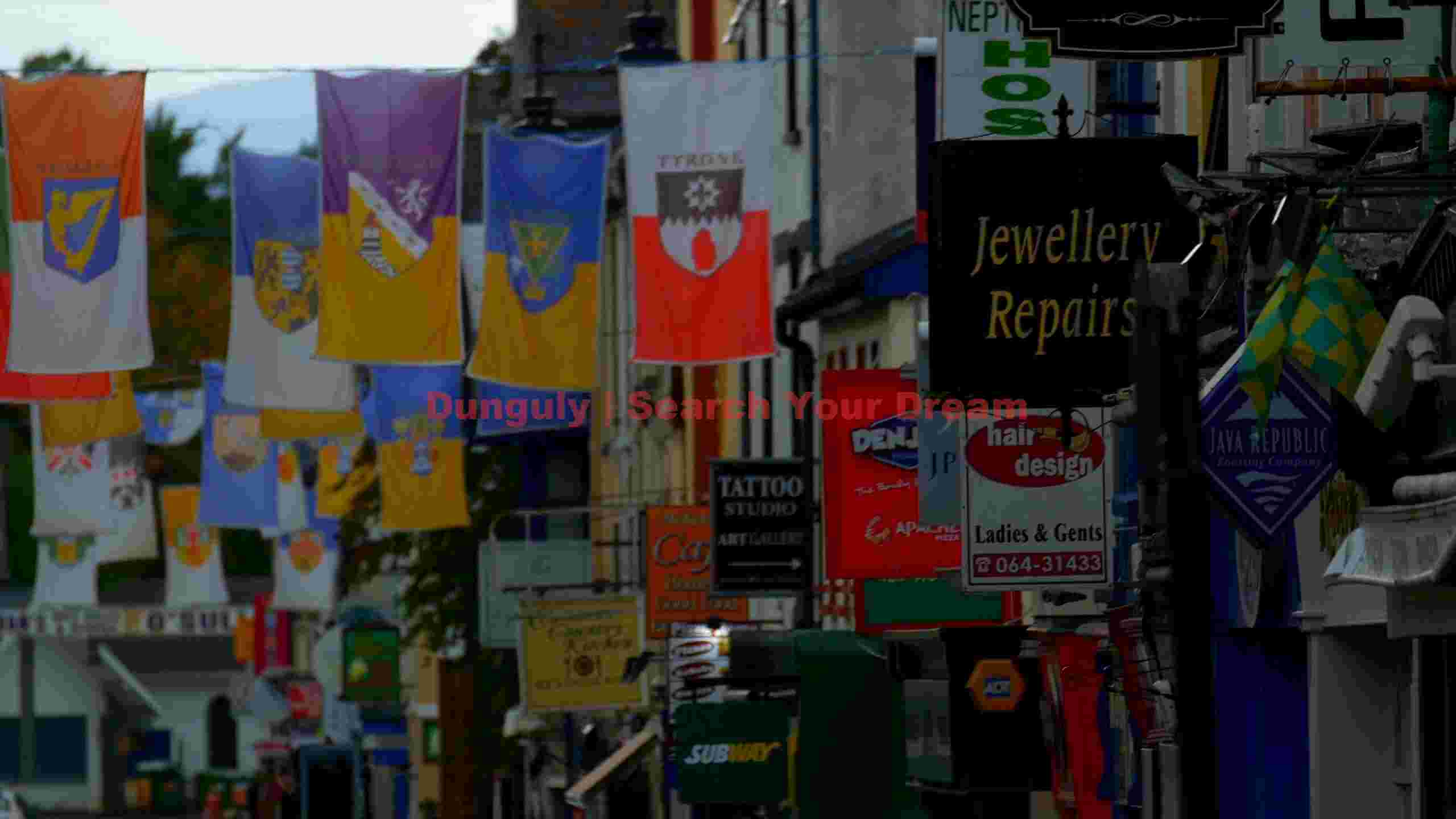 vibrant irish street with heraldic county flags and shop signs vibrant irish street with heraldic county flags and shop signs