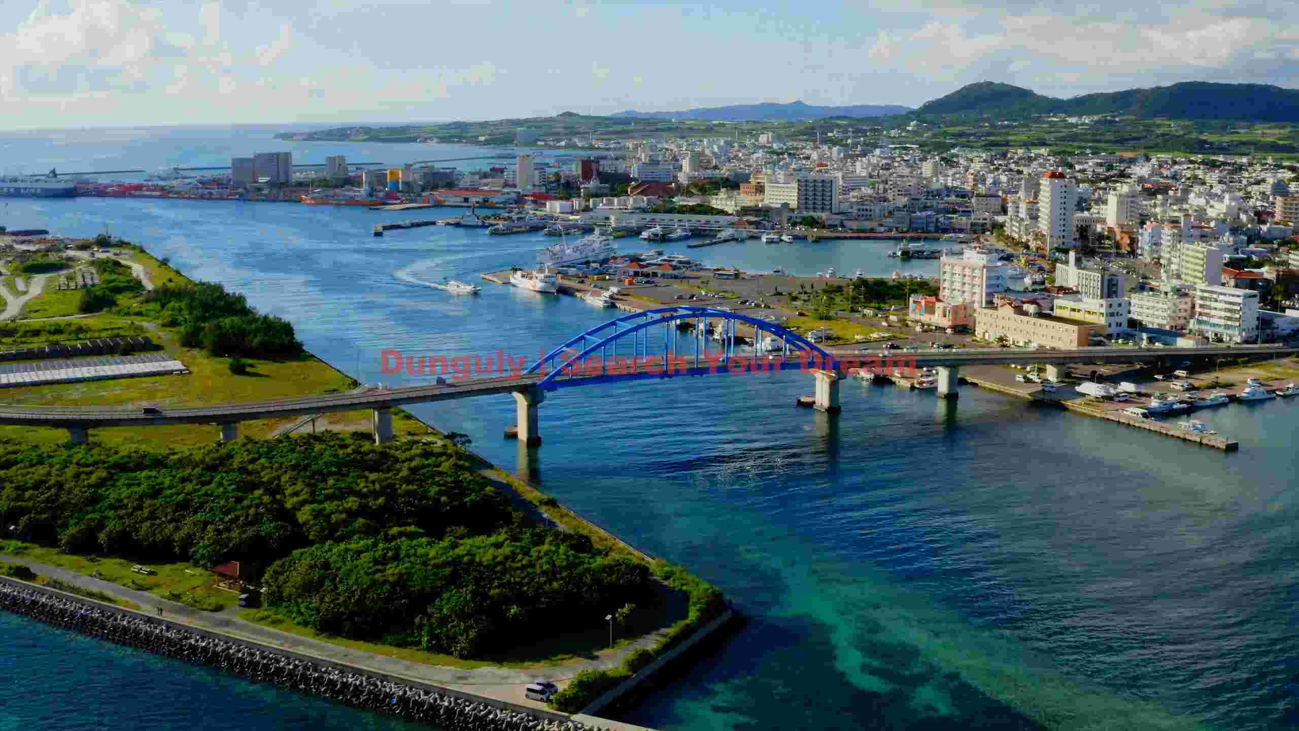 vibrant okinawa coastal cityscape with blue arch bridge vibrant okinawa coastal cityscape with blue arch bridge