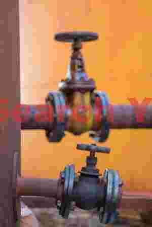 At Home weathered industrial valves on orange backdrop