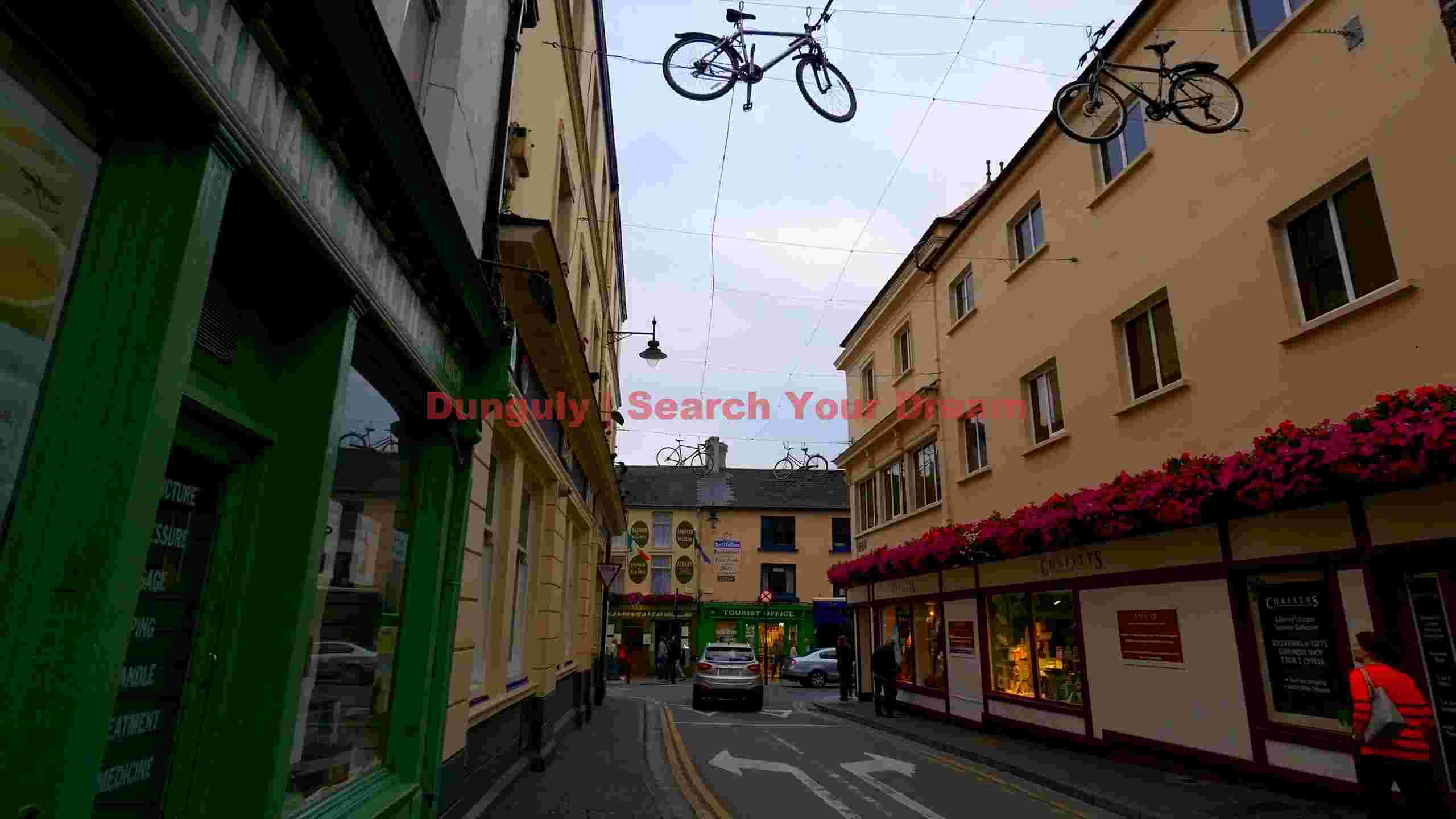 whimsical bicycles over a charming town street whimsical bicycles over a charming town street