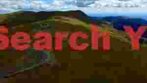 winding mountain road through lush green hills