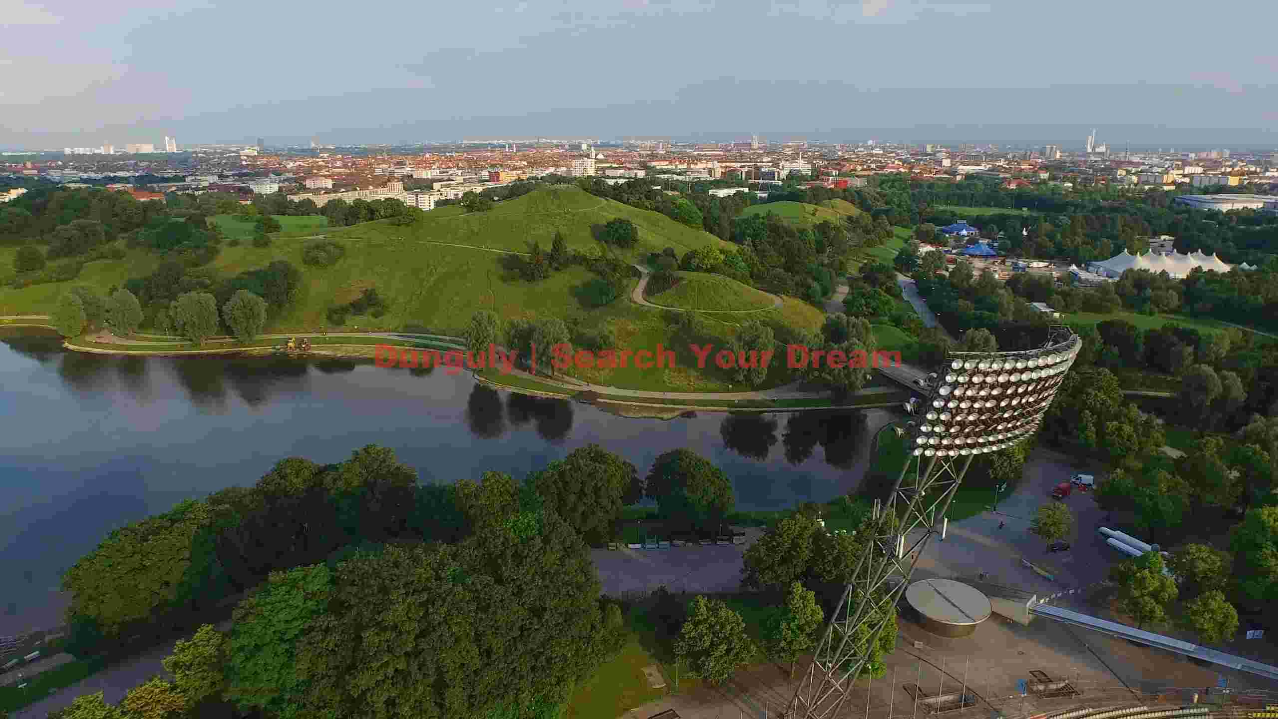 aerial view of olympic park munich with lake and stadium lights aerial view of olympic park munich with lake and stadium lights