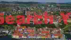charming european lakeside town with vineyards aerial view