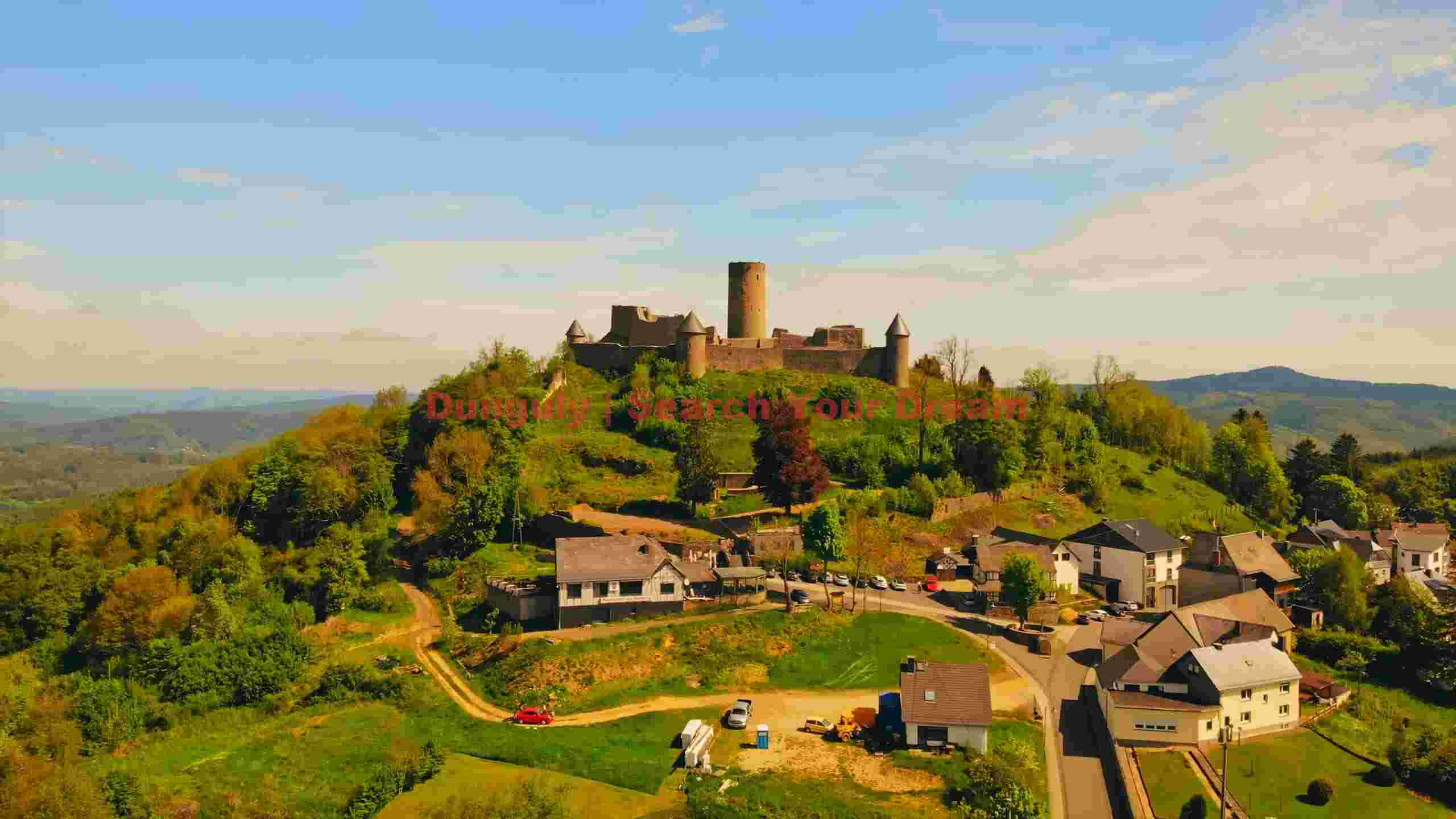 historic castle overlooking a scenic village and valley historic castle overlooking a scenic village and valley