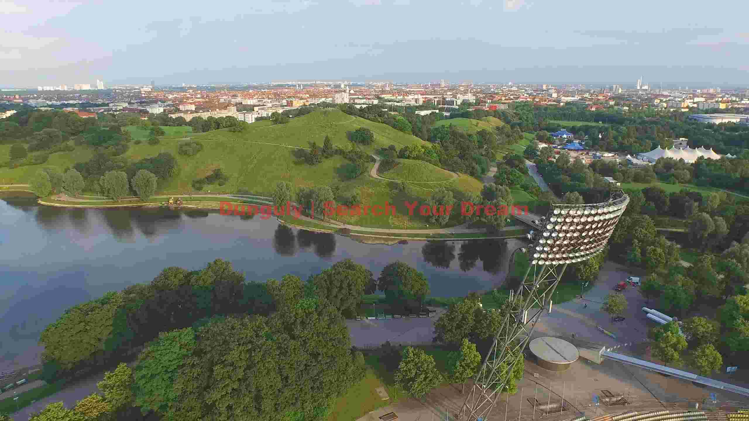 munich olympic park aerial view with lake and stadium lights munich olympic park aerial view with lake and stadium lights