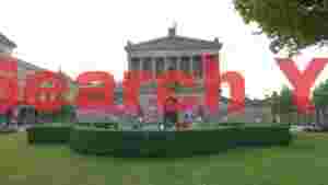 neoclassical art museum facade with lush green lawn