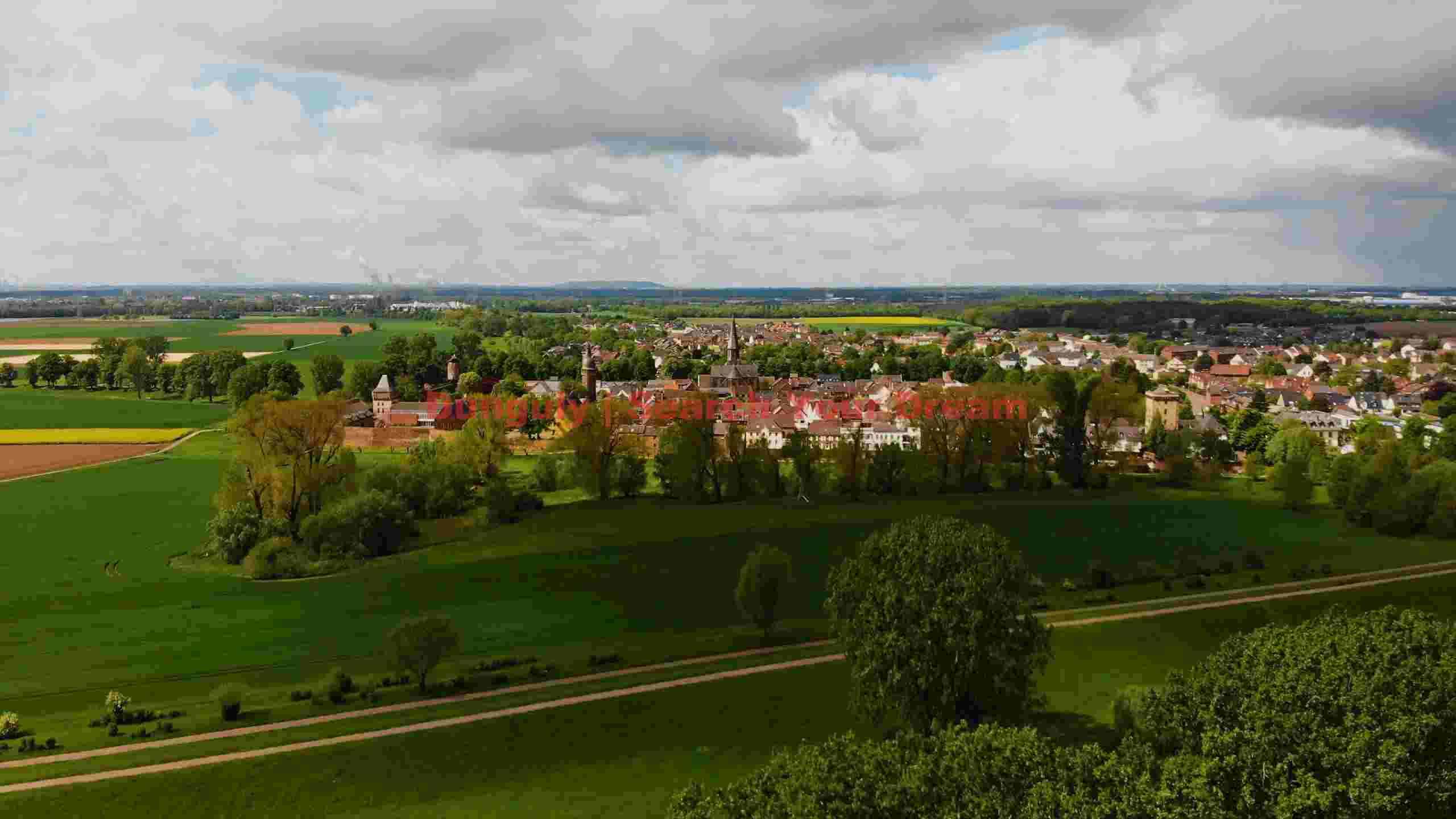 panoramic view of historic village and lush countryside panoramic view of historic village and lush countryside