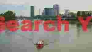 riverfront cityscape with a small boat