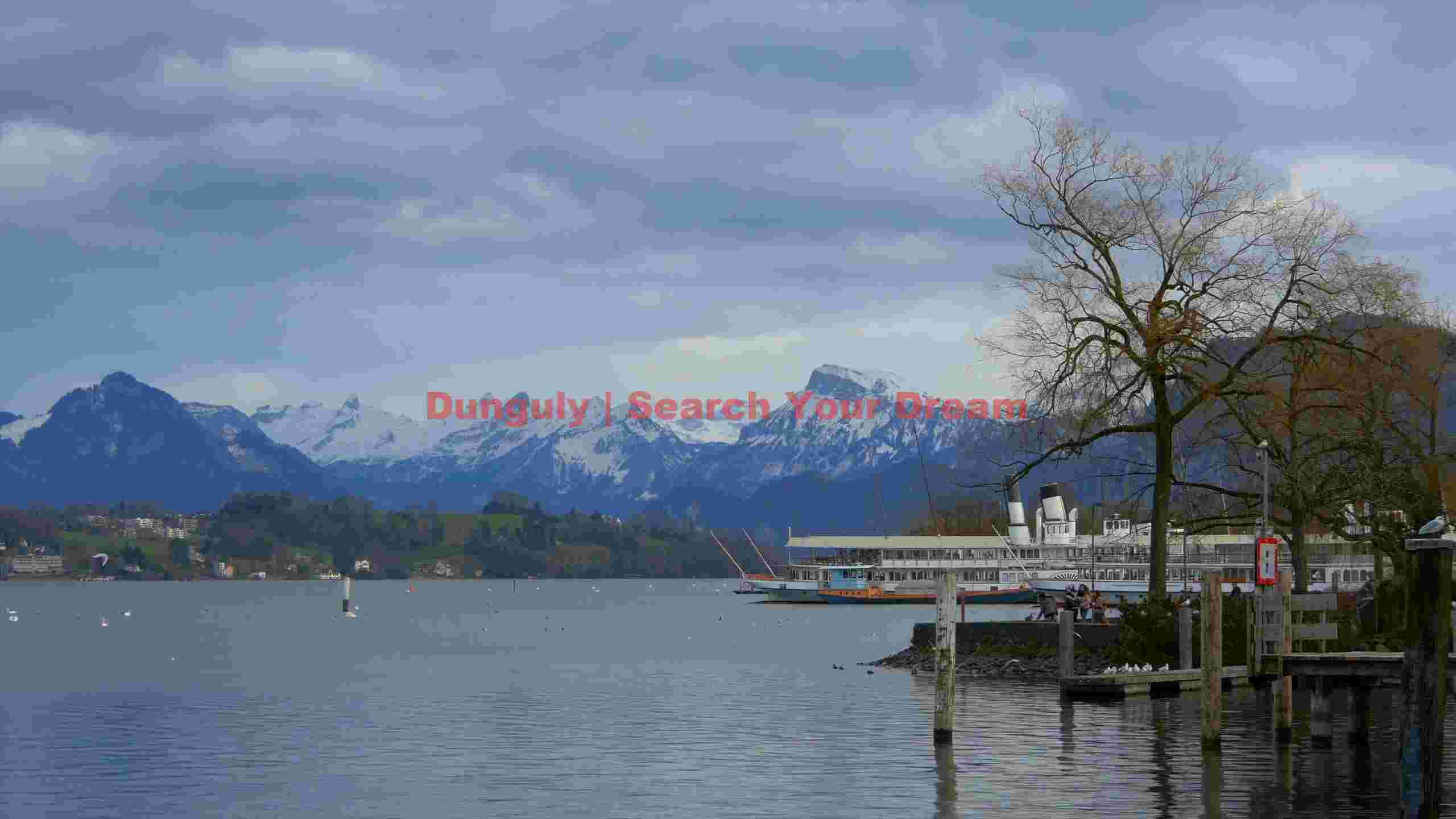 serene alpine lake vista with boats and snow capped peaks serene alpine lake vista with boats and snow capped peaks