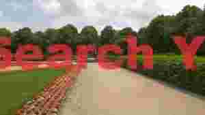 serene park path with floral borders and fountain