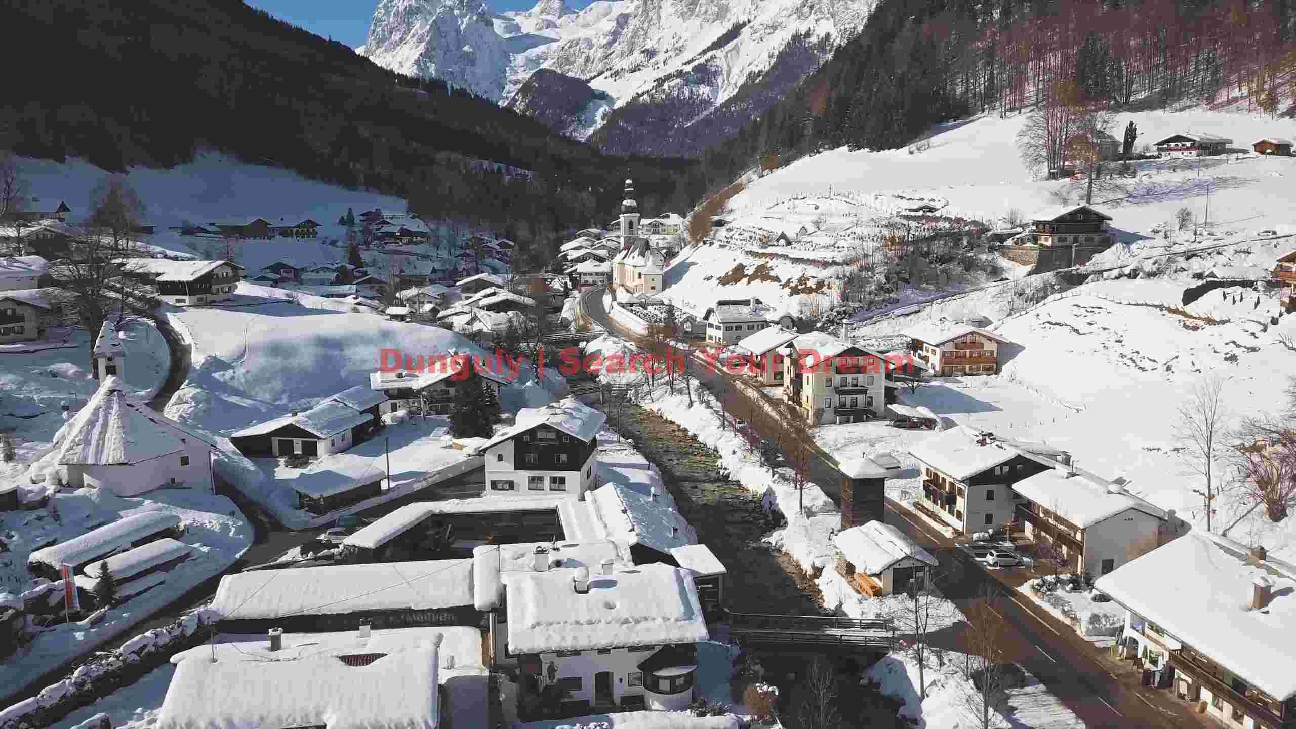 snowy alpine village in majestic mountain valley snowy alpine village in majestic mountain valley