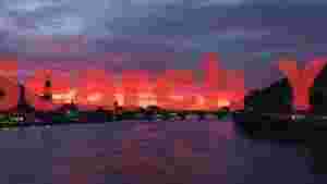 vibrant sunset over heidelberg bridge and river